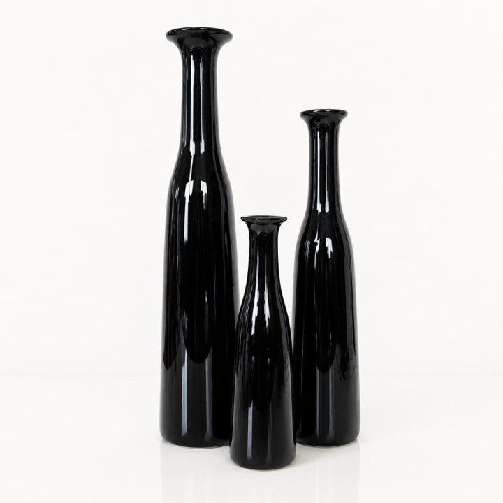 Close-up of three black handmade vases