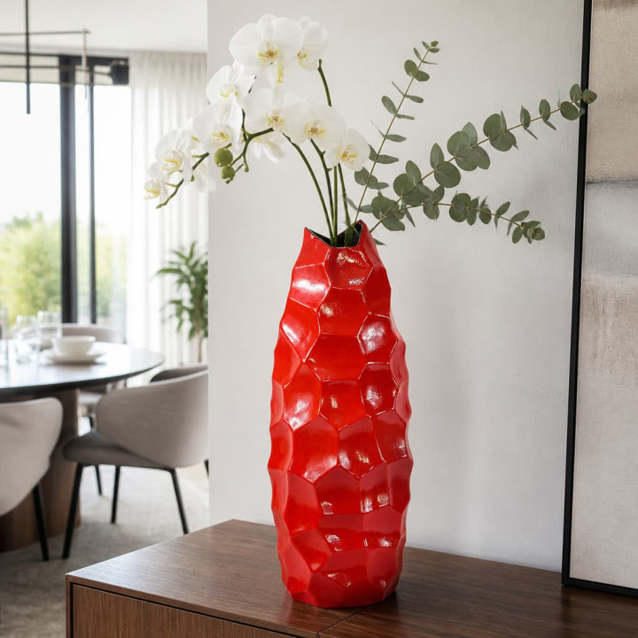 Red diamond vase with orchids on sideboard